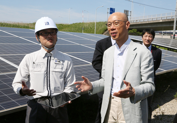 環境局局長黃錦星（右）考察沿東京成田機場快線Sky Access鐵路鋪設的太陽能光伏板設施。